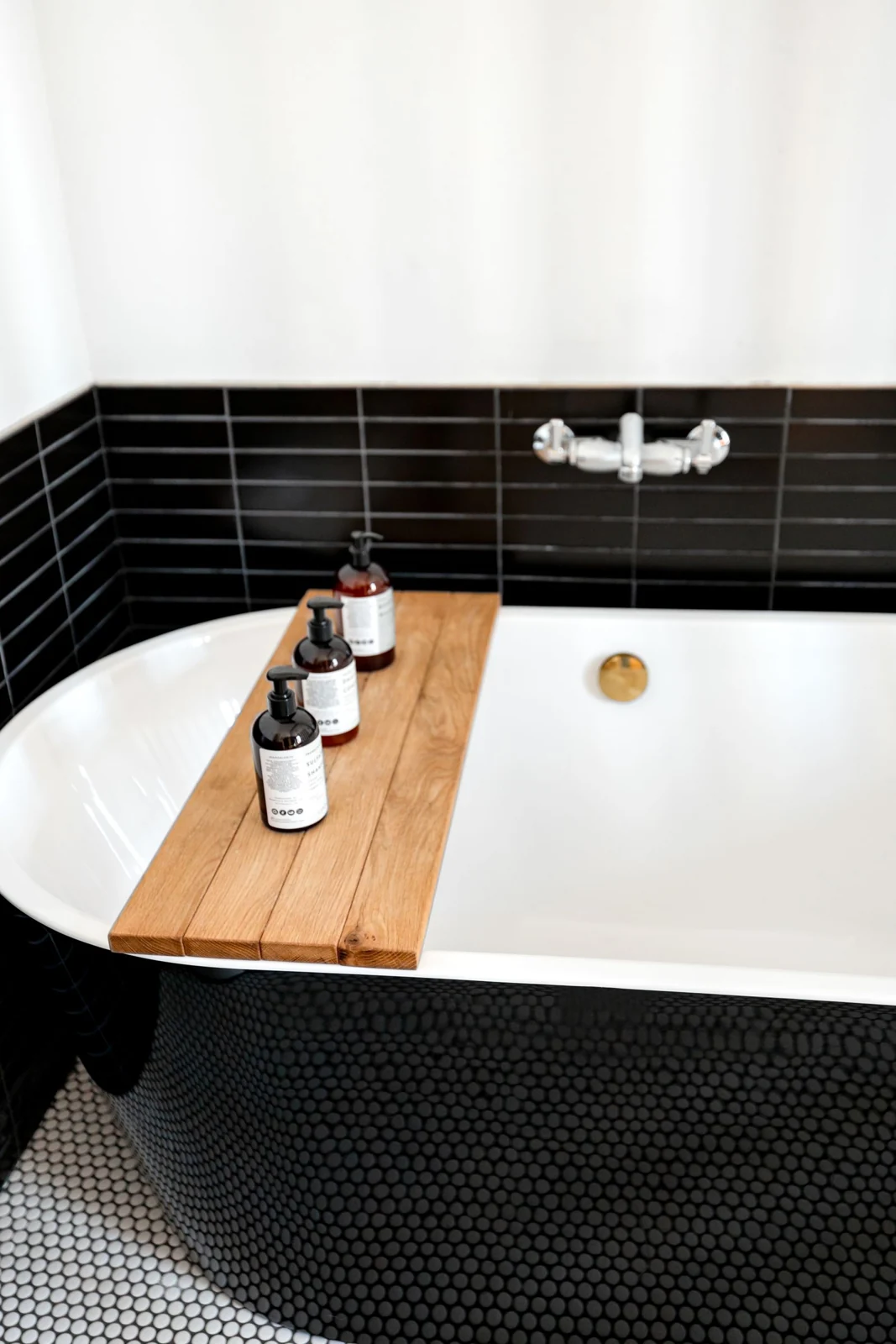 Bath tray resting over a fitted bath