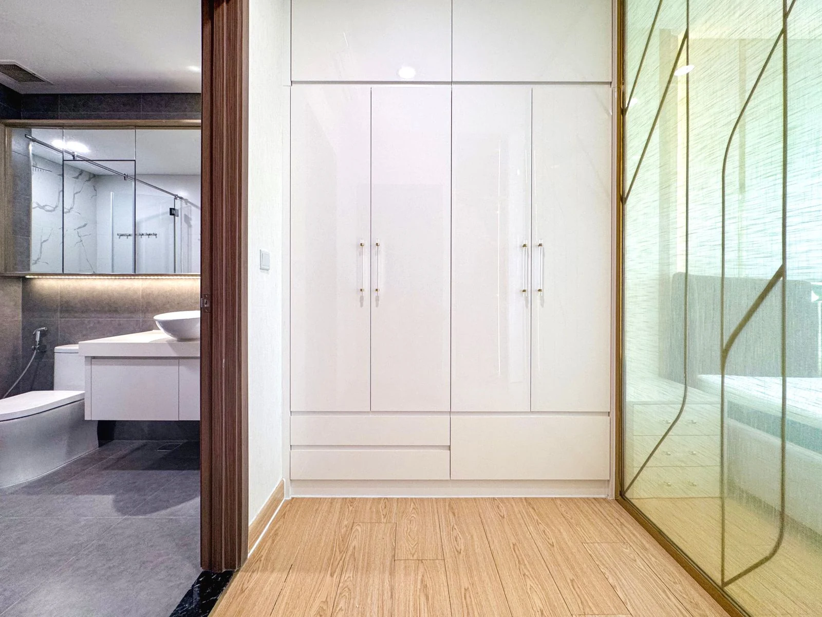 Bathroom storage cupboards beside a shower