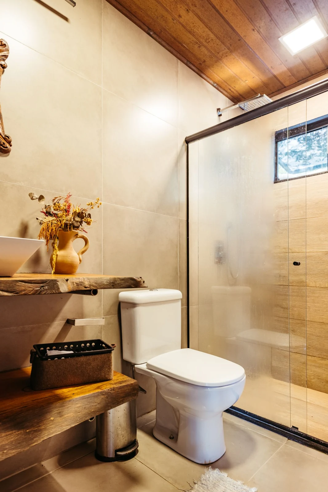 A warm, rustic bathroom with wooden elements and natural light