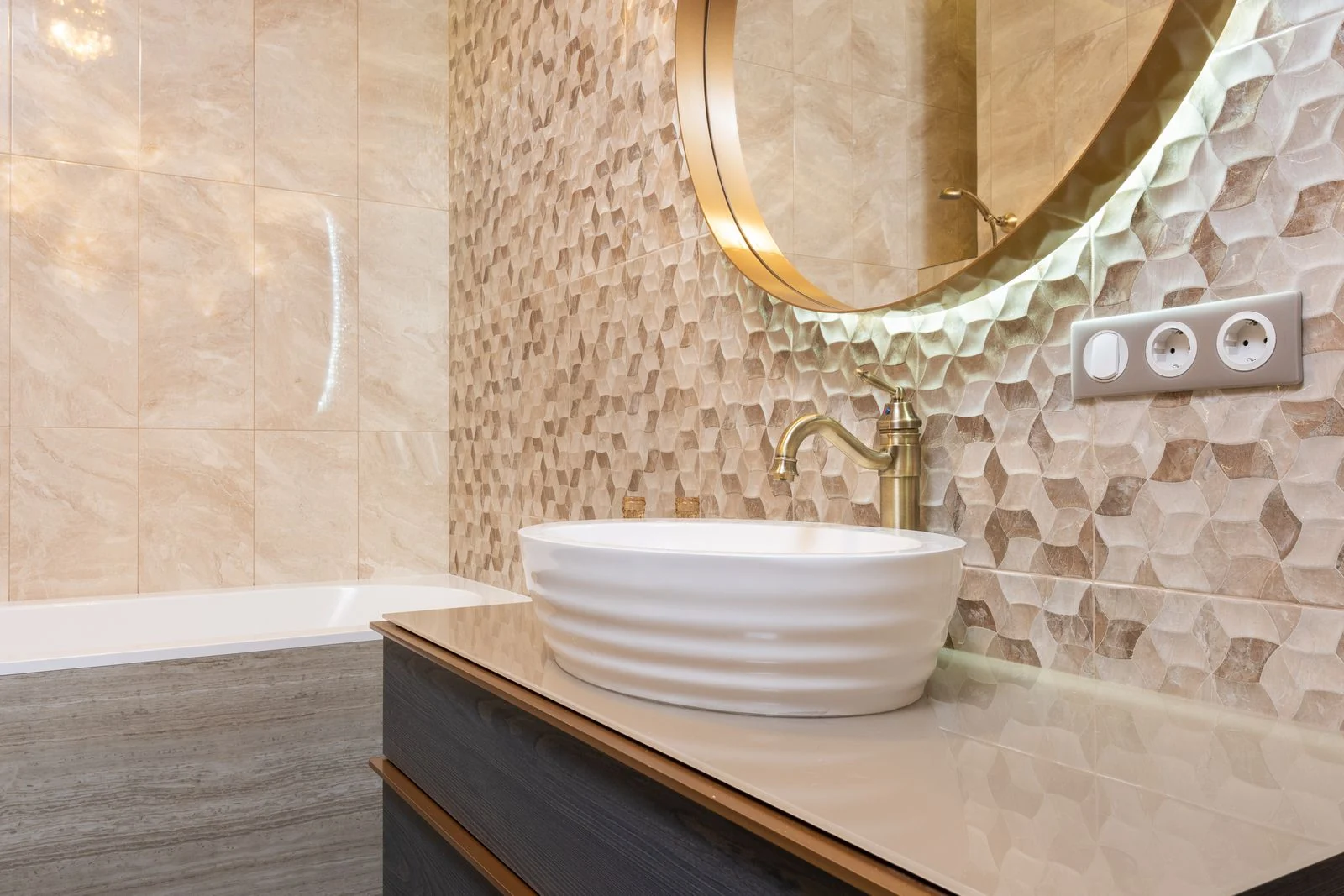 Bathroom basin beneath a round mirror