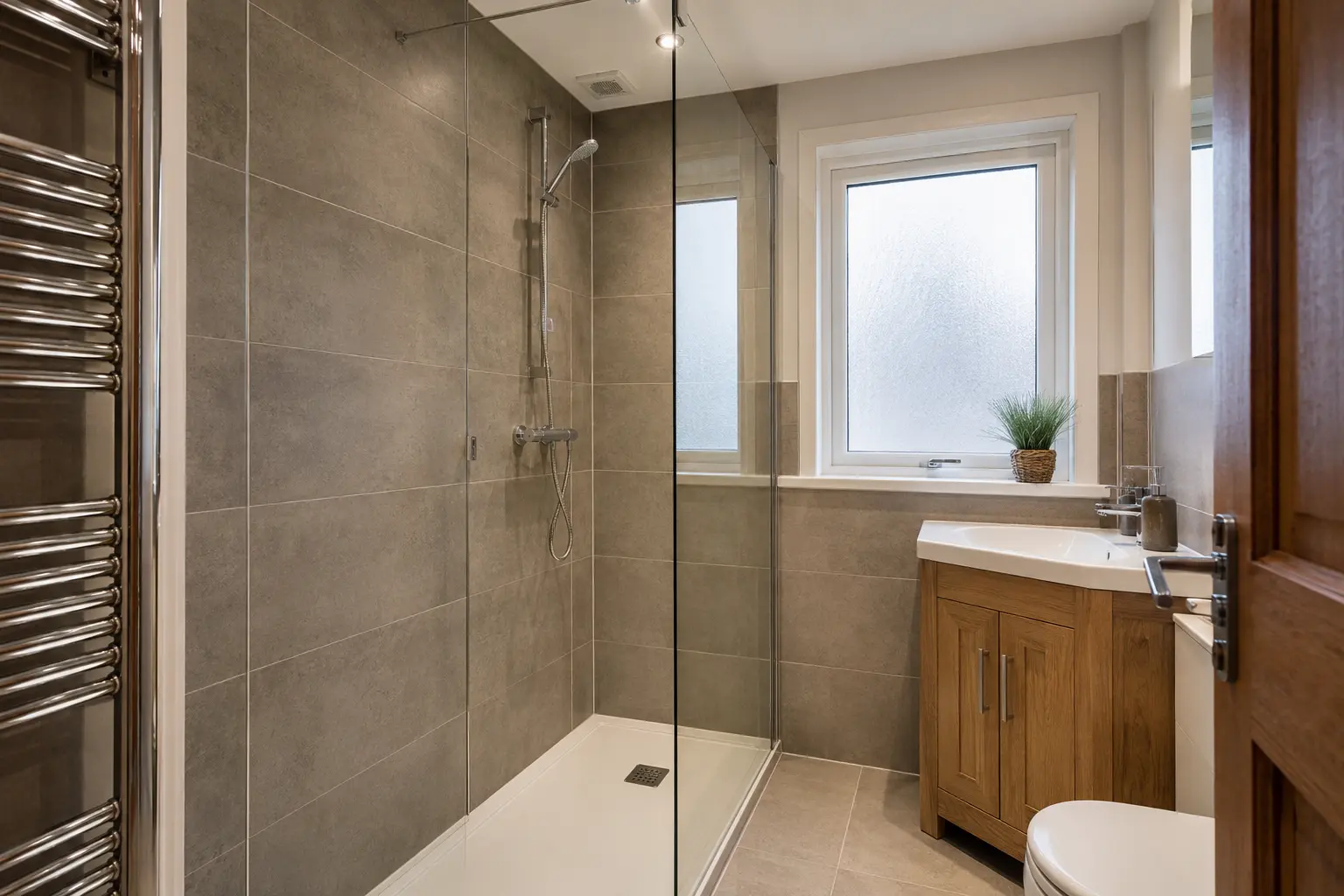 Walk-in shower bathroom with warm grey tiles in a Glasgow home